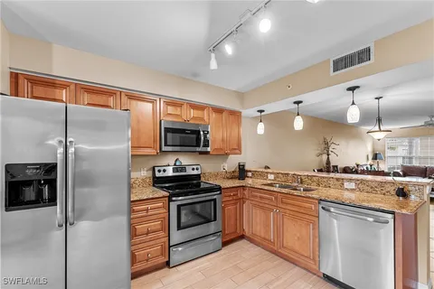 a kitchen with a sink stove and refrigerator