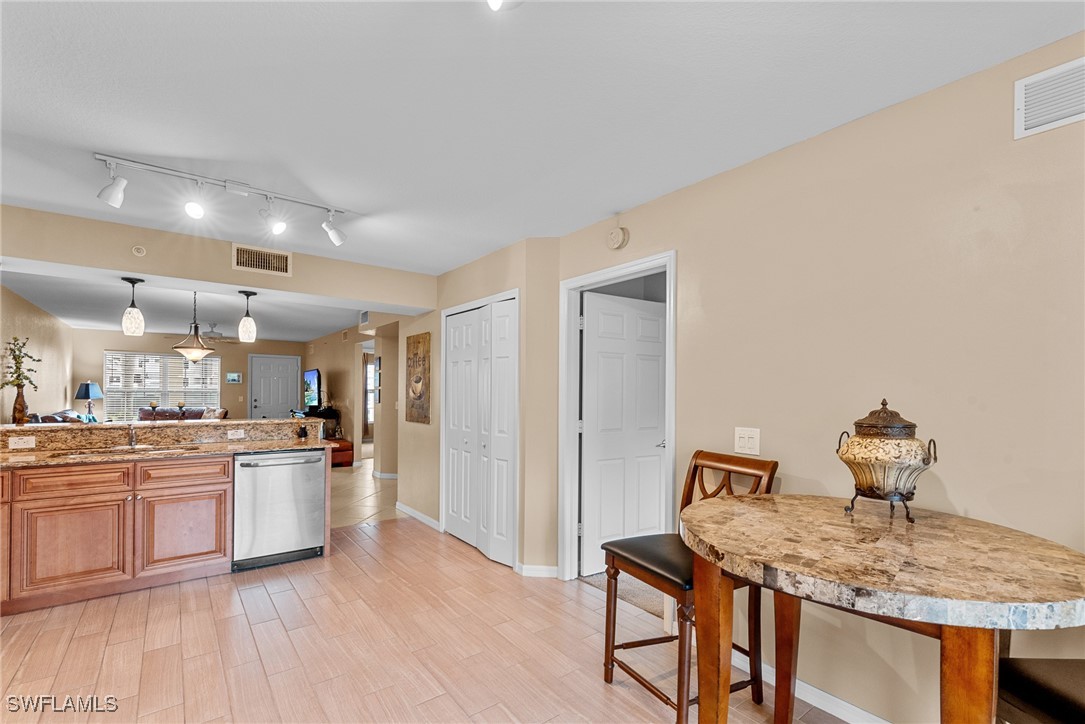4965 Sandra Bay Drive, Unit 103 Naples, FL 34109 - Photo 5 of 30 a kitchen with stainless steel appliances granite countertop a sink stove and refrigerator