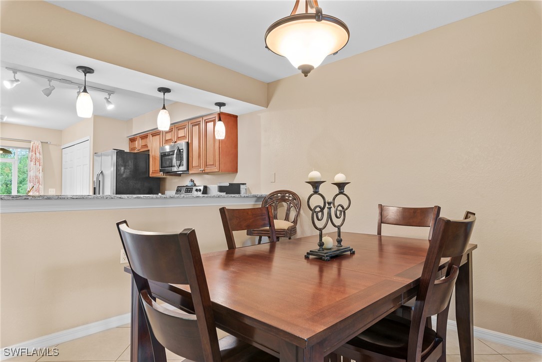 4965 Sandra Bay Drive, Unit 103 Naples, FL 34109 - Photo 6 of 30 a view of a dining room with furniture