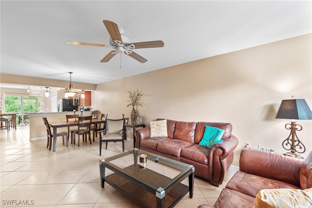 4965 Sandra Bay Drive, Unit 103 Naples, FL 34109 - Photo 8 of 30 a living room with furniture and a large window