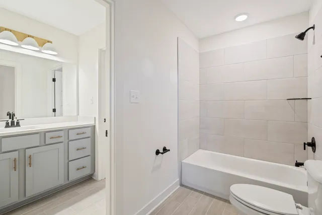a bathroom with a toilet a sink and bathtub