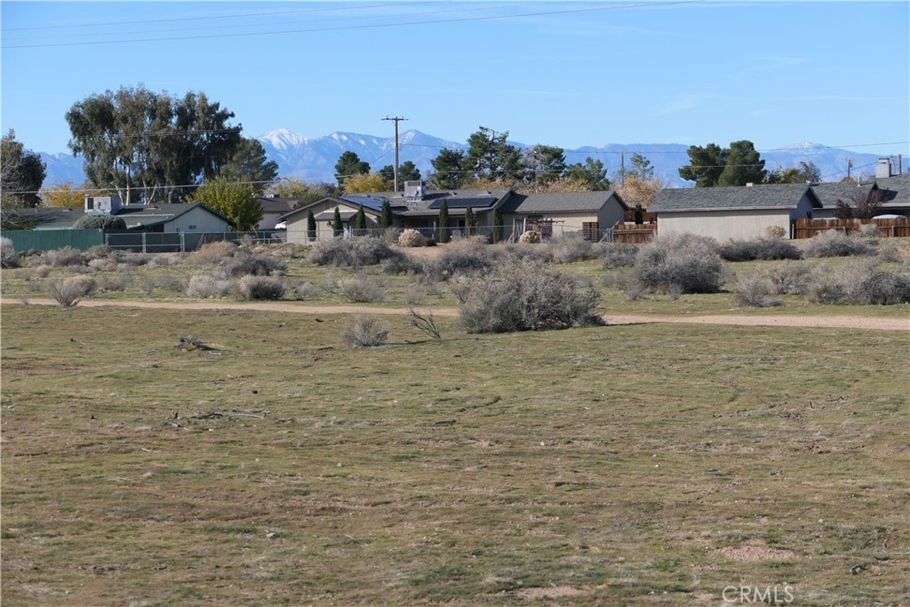 0 Passo Road Apple Valley, CA 92308 - Photo 9 of 16 a view of a dry yard with wooden fence