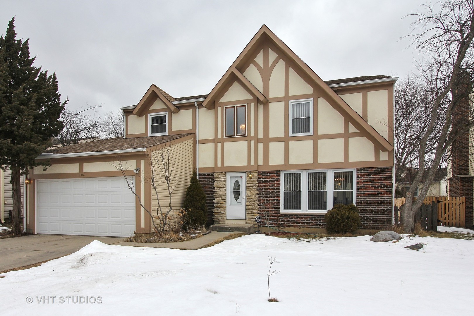 1104 Devonshire Road Buffalo Grove, IL 60089 - Photo 1 of 10 a view of a white house with a large tree