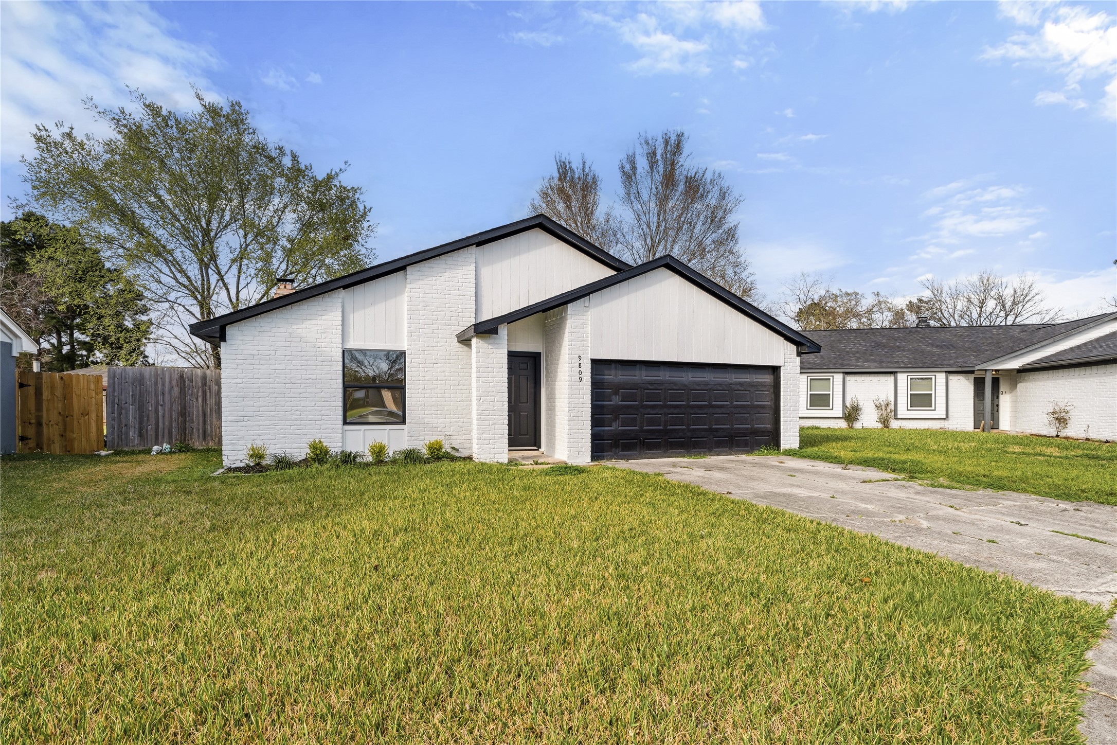 9809 Wren Court Conroe, TX 77385 - Photo 2 of 22 a front view of a house with a yard and garage