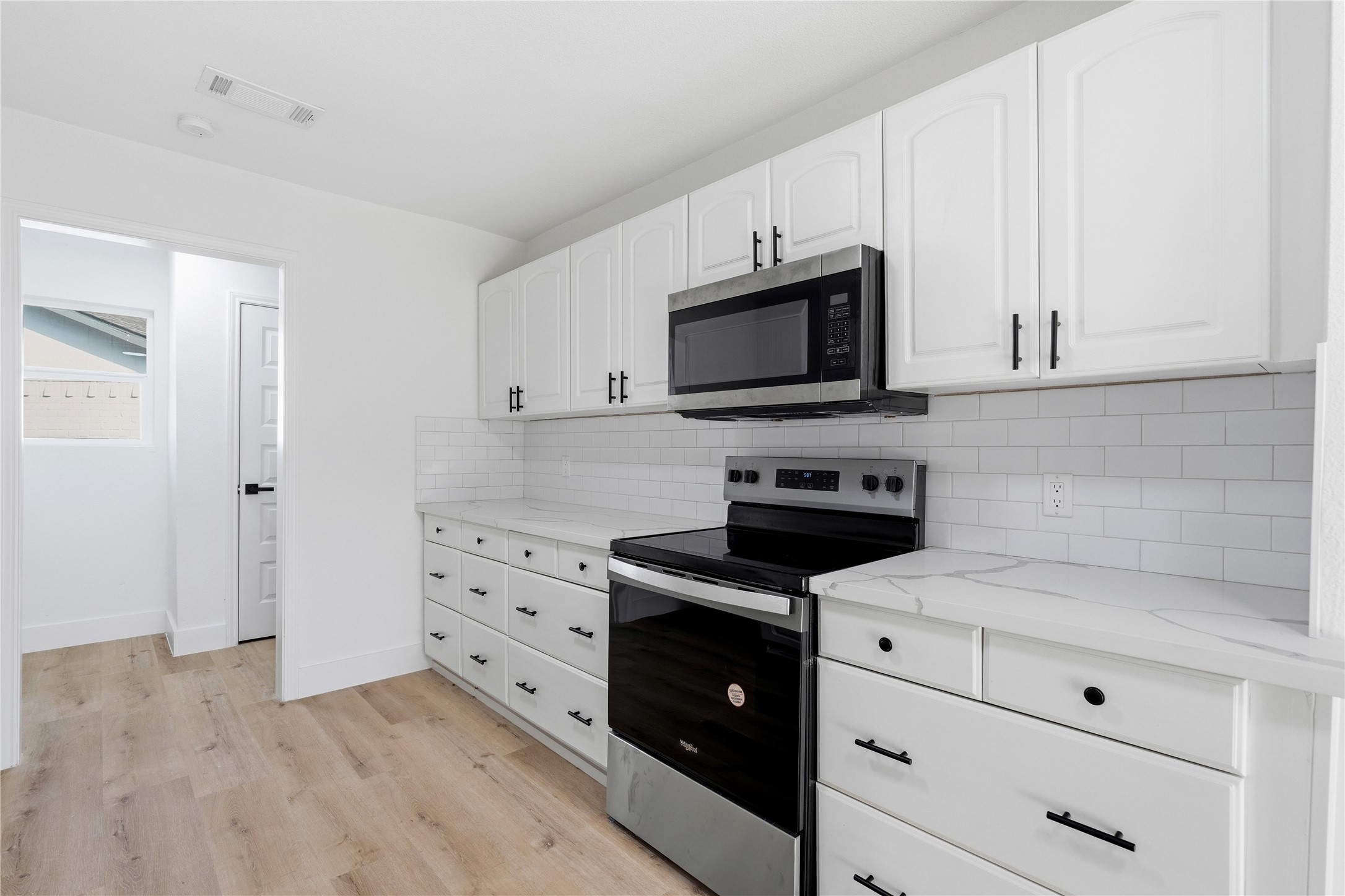 9809 Wren Court Conroe, TX 77385 - Photo 10 of 22 a kitchen with white cabinets appliances and sink