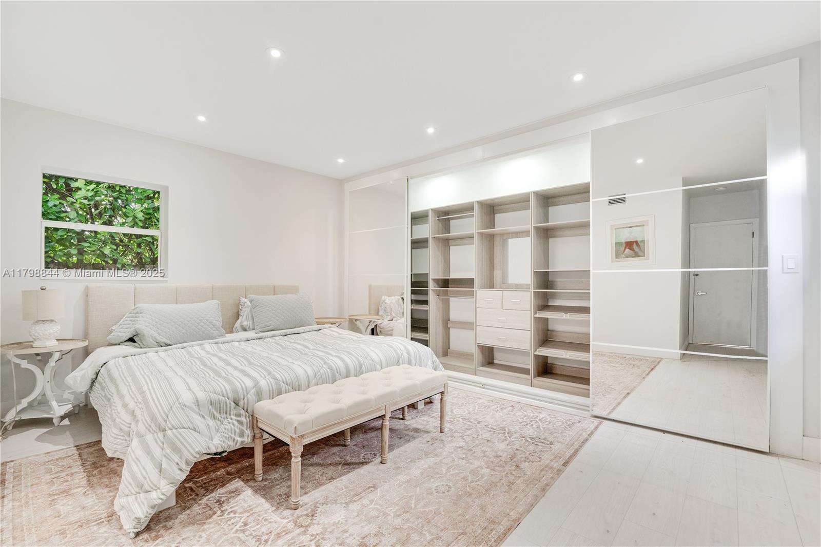9025 Hawthorne Avenue Surfside, FL 33154 - Photo 15 of 58 a bedroom with a large bed and a walk in closet