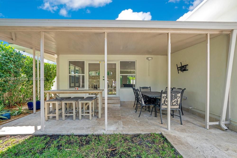 9025 Hawthorne Avenue Surfside, FL 33154 - Photo 34 of 58 a view of a patio with table and chairs