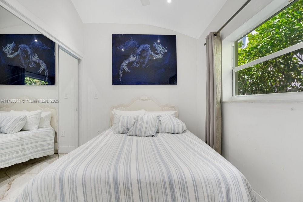 9025 Hawthorne Avenue Surfside, FL 33154 - Photo 35 of 58 a bedroom with a large bed and a couch