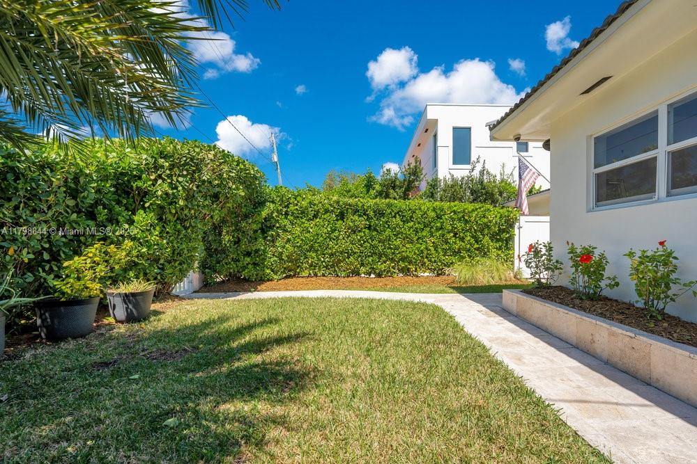 9025 Hawthorne Avenue Surfside, FL 33154 - Photo 40 of 58 a front view of a house with a yard