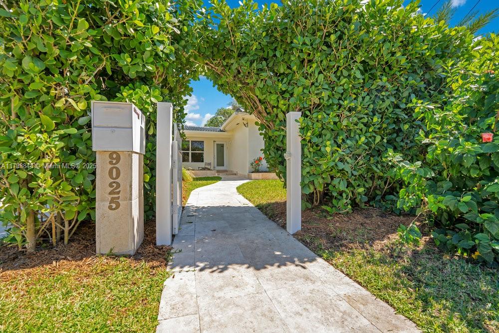9025 Hawthorne Avenue Surfside, FL 33154 - Photo 58 of 58 a view of a outdoor space in front of a house with large trees