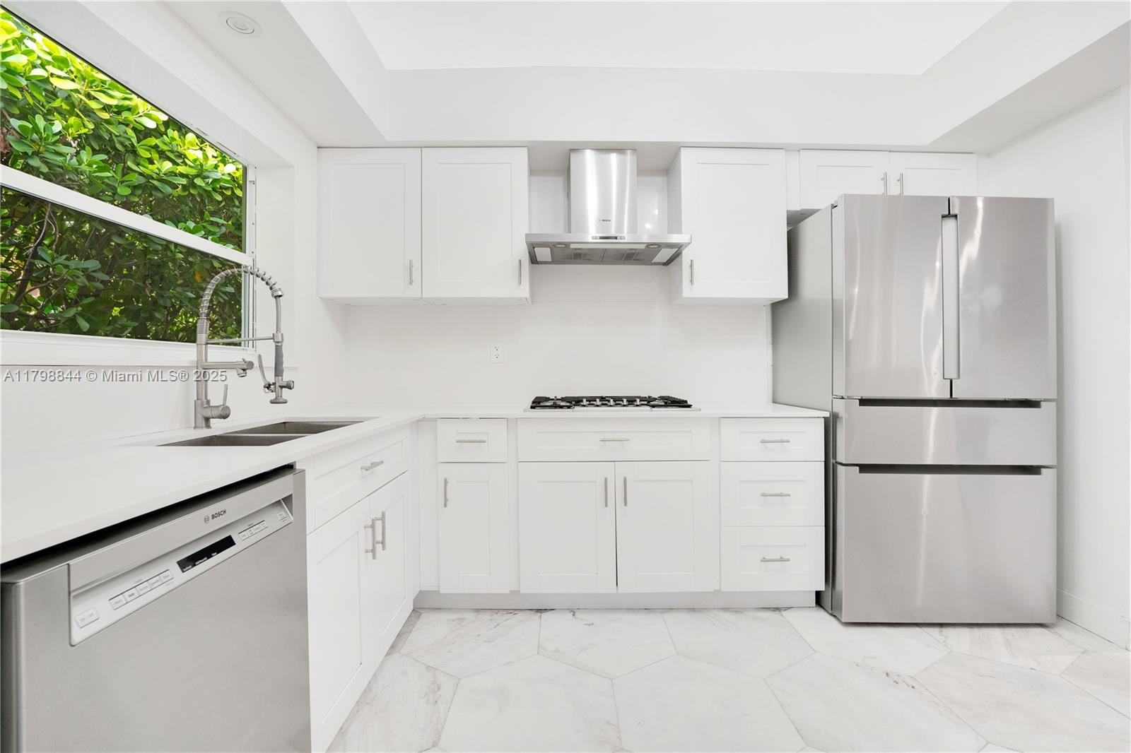 9025 Hawthorne Avenue Surfside, FL 33154 - Photo 6 of 58 a kitchen with appliances cabinets and a sink