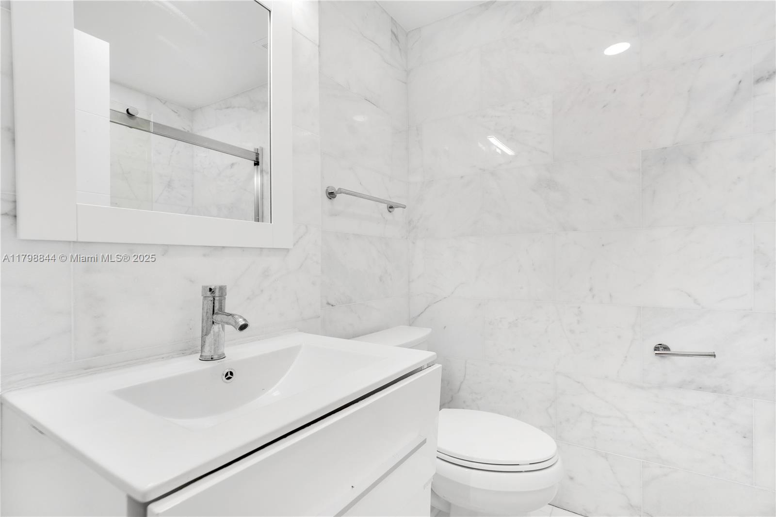 9025 Hawthorne Avenue Surfside, FL 33154 - Photo 10 of 58 a white toilet sitting next to a bathroom sink