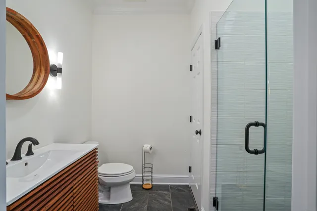 a bathroom with a sink a toilet and a mirror