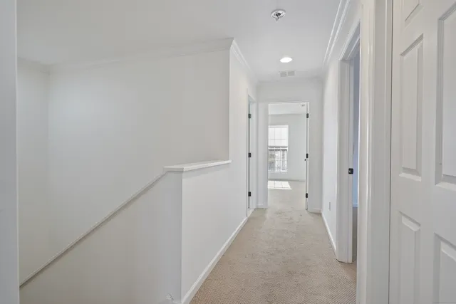 a view of a hallway with wooden shelves