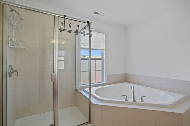 an empty room with windows and ceiling fan