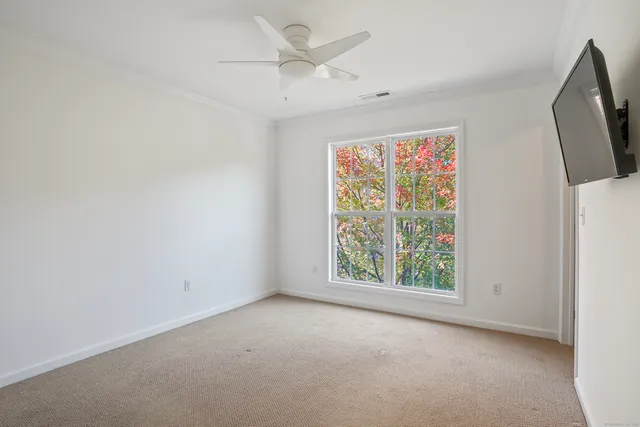 an empty room with windows and closet