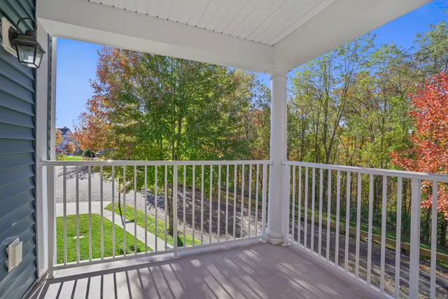 a view of an empty room with wooden floor and entryway