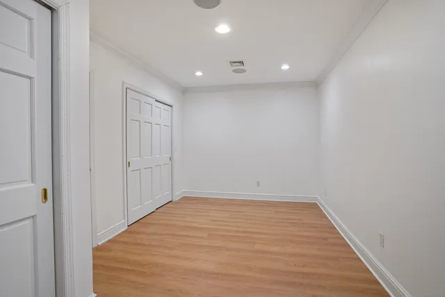 a view of room with wooden floor