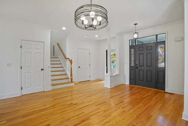 a view of empty room with wooden floor and window