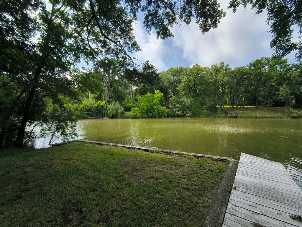 180 Arrowhead Street Mabank, TX 75156 - Photo 15 of 26 a view of a lake with a yard