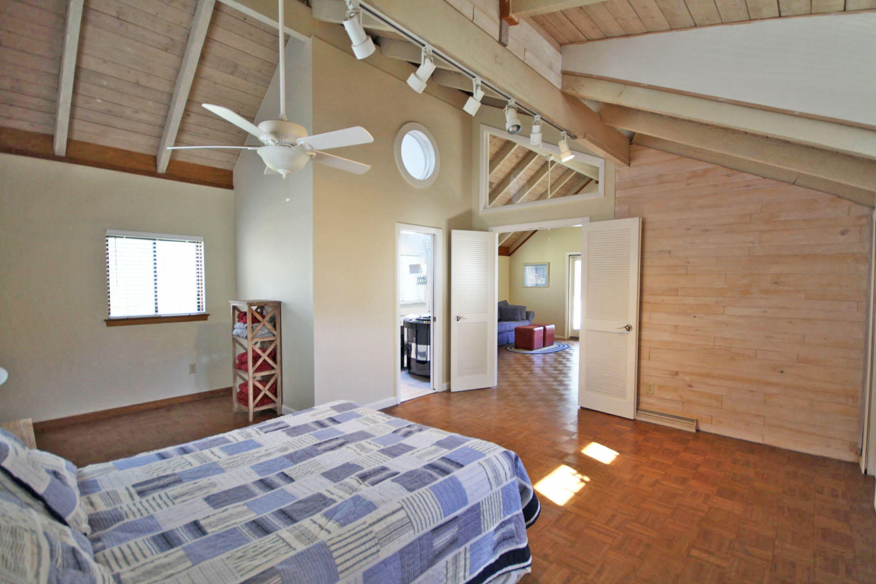 38 Fells Pond Road Mashpee, MA 02649 - Photo 16 of 22 a bedroom with a bed and a chandelier