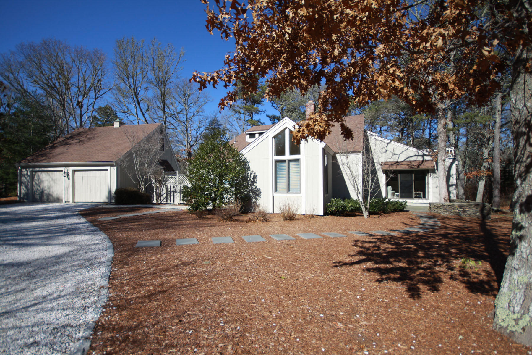 38 Fells Pond Road Mashpee, MA 02649 - Photo 2 of 22 a front view of a house with a yard and garage