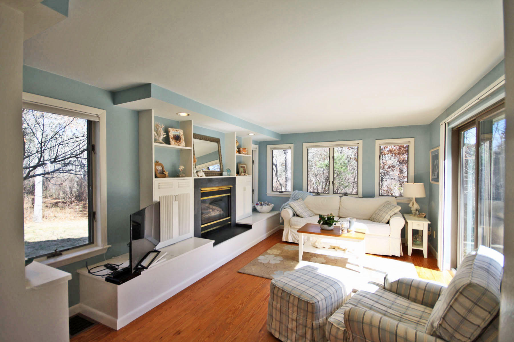 38 Fells Pond Road Mashpee, MA 02649 - Photo 9 of 22 a living room with furniture a flat screen tv and a fireplace