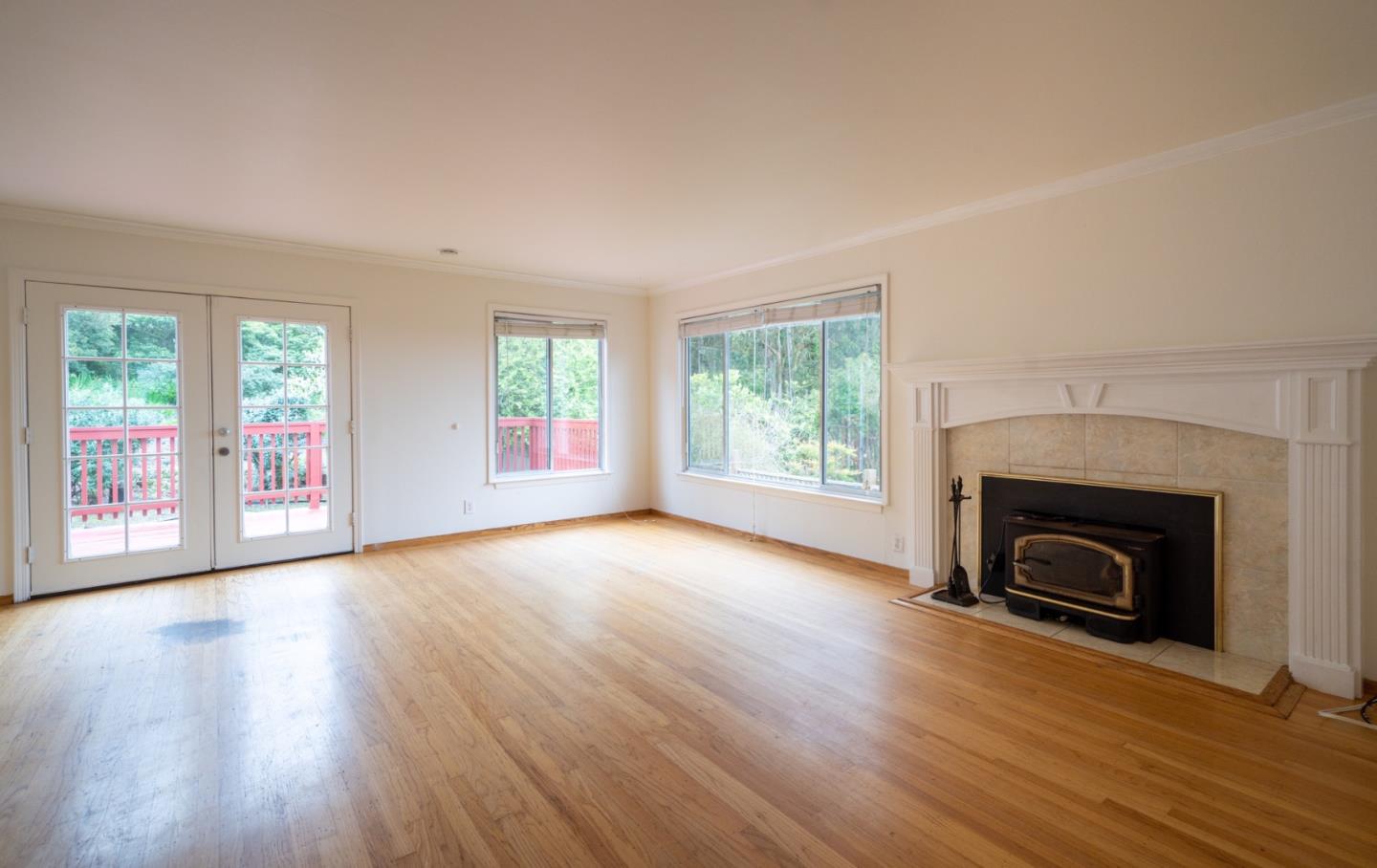 616 Brighton Road Pacifica, CA 94044 - Photo 3 of 14 an empty room with wooden floor fireplace and windows