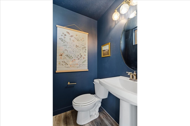 370 West Knights Lane Layton, UT 84041 - Photo 7 of 31 Pedestal sink with brushed nickel faucet, round mirror, and a three-light vanity fixture