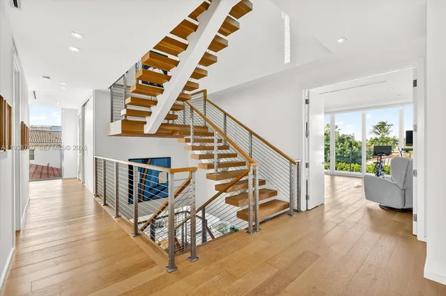 a view of entryway and hall with wooden floor