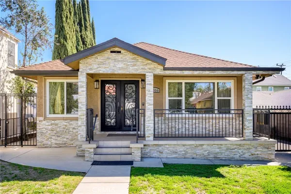 a front view of a house with a garden