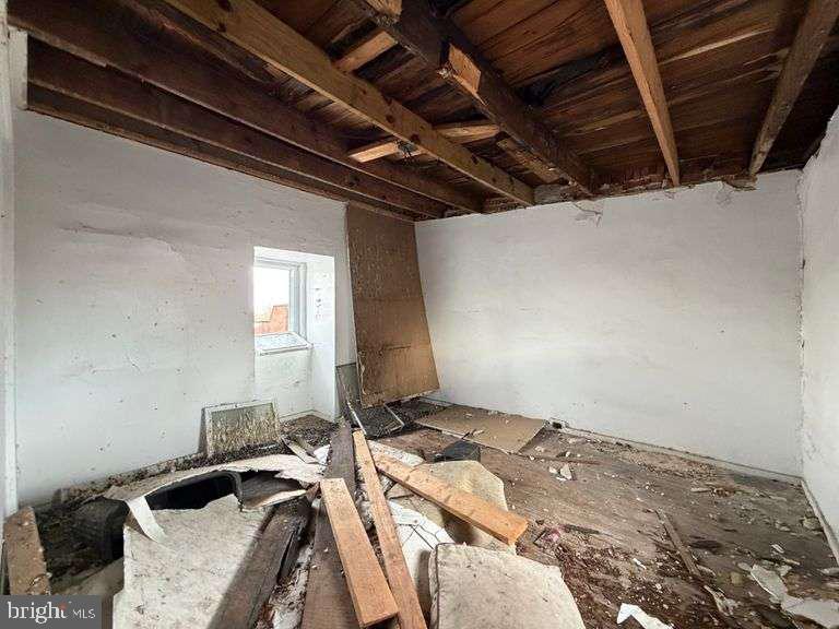 3923 Ridgewood Avenue Baltimore, MD 21215 - Photo 14 of 18 a bed sitting in a bedroom next to a window