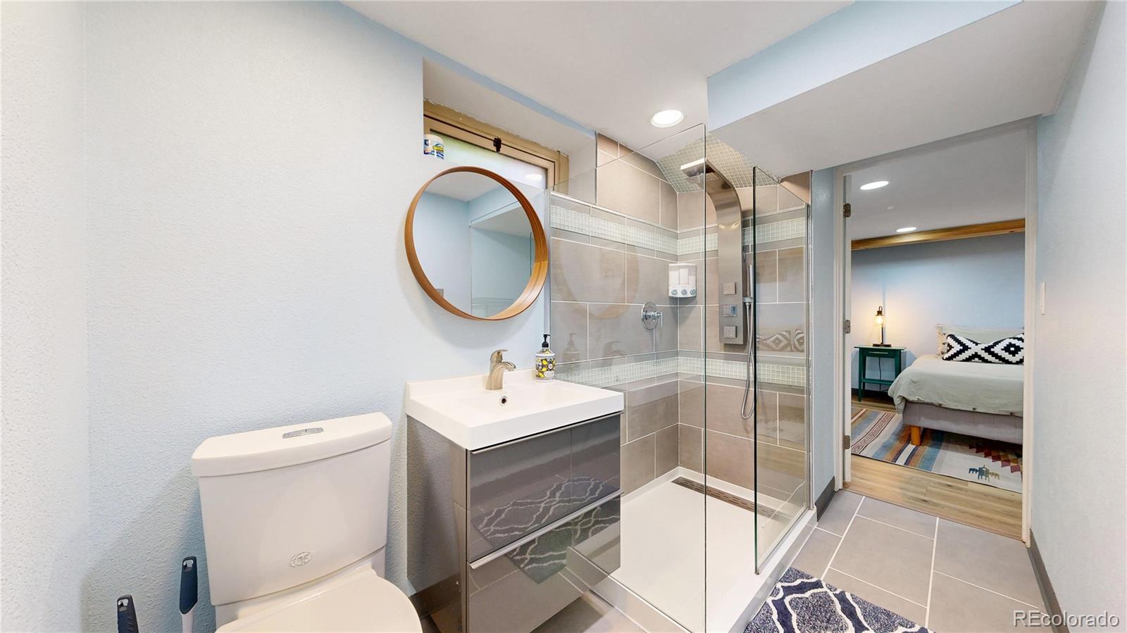 940 Grape Street Denver, CO 80220 - Photo 31 of 50 a bathroom with a toilet a sink and mirror