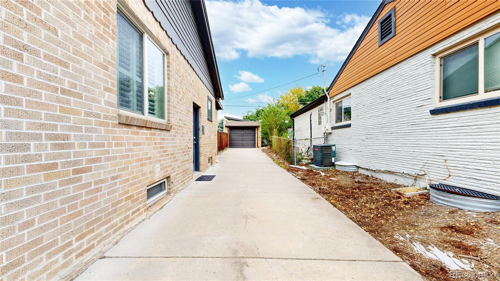 940 Grape Street Denver, CO 80220 - Photo 39 of 50 a view of a white house with wooden fence