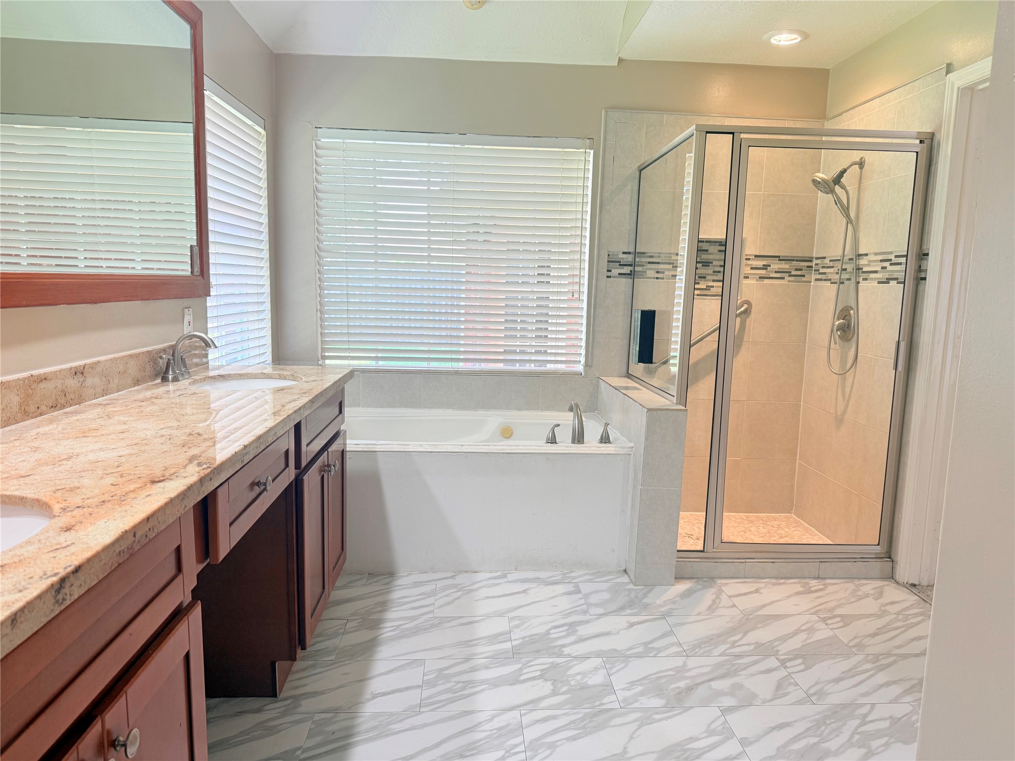 5010 Rebel Ridge Drive Sugar Land, TX 77478 - Photo 11 of 23 a bathroom with a granite countertop bathtub and a shower