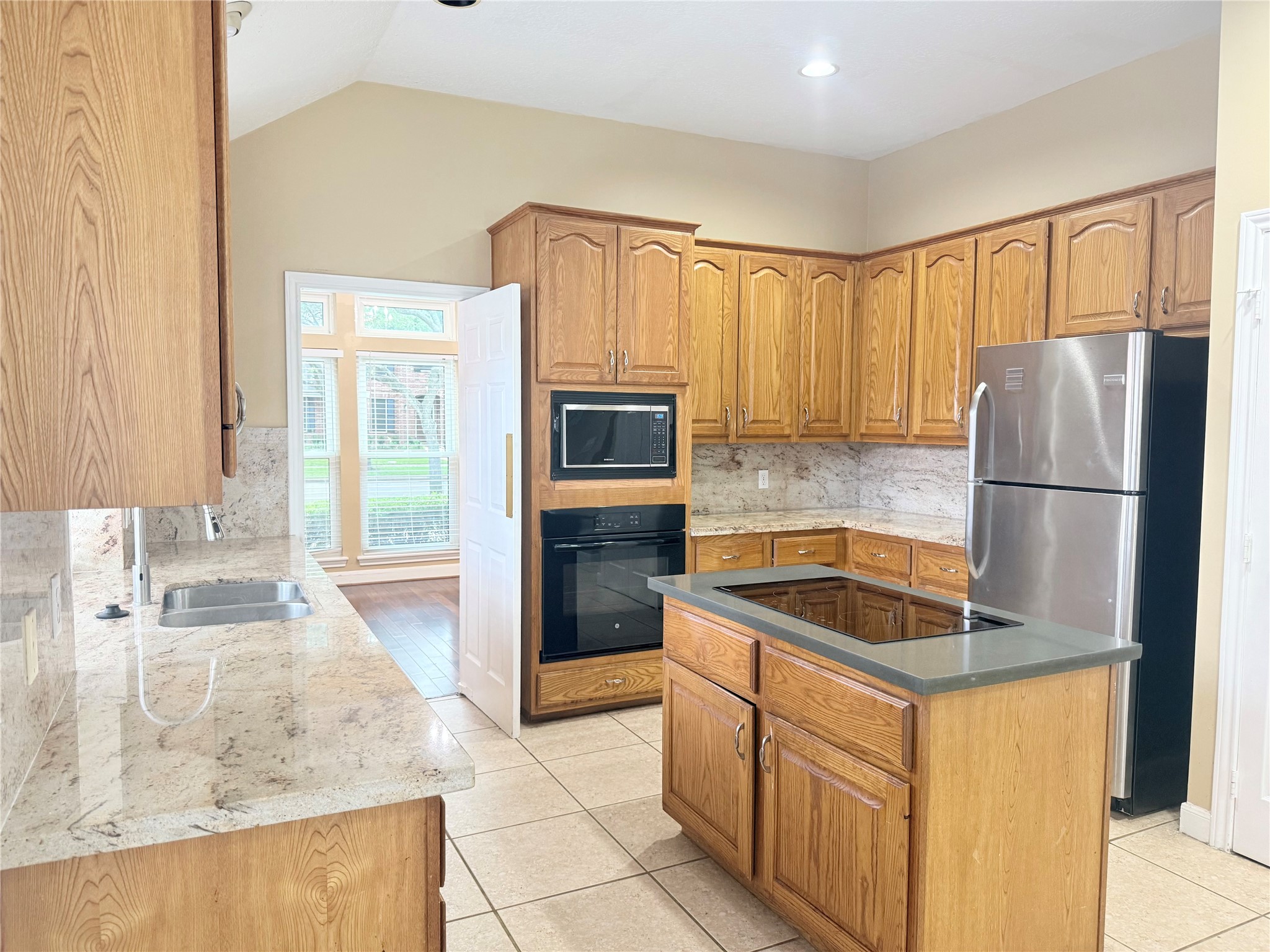 5010 Rebel Ridge Drive Sugar Land, TX 77478 - Photo 3 of 23 a kitchen with granite countertop a refrigerator and a sink