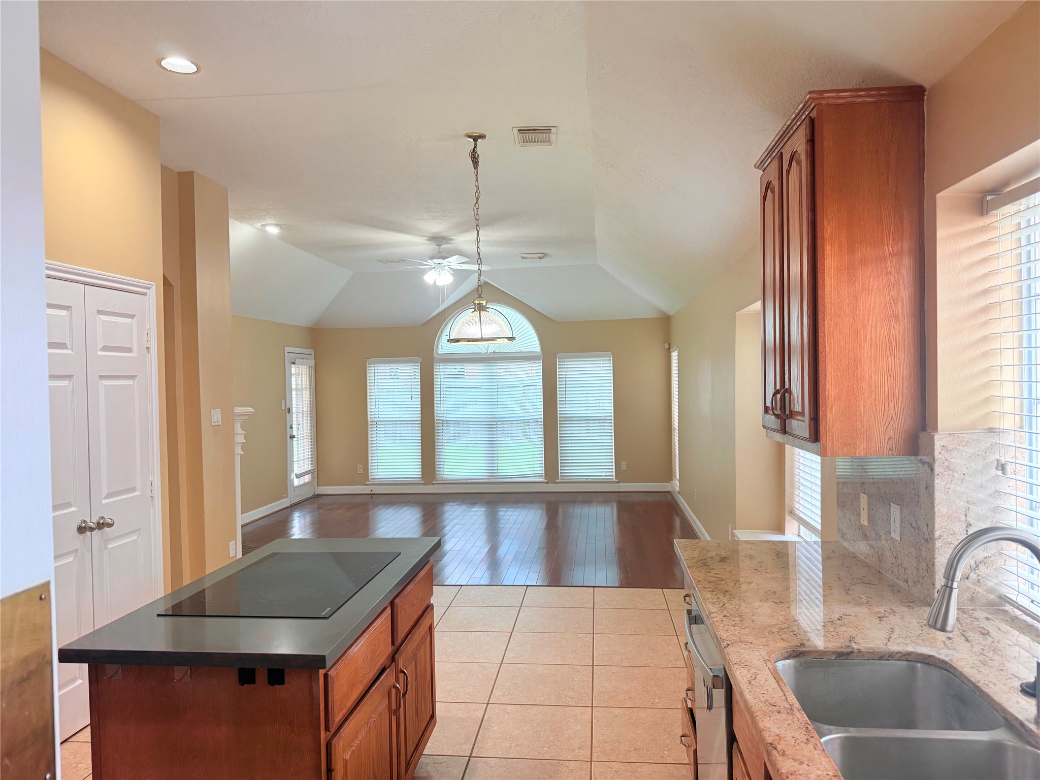 5010 Rebel Ridge Drive Sugar Land, TX 77478 - Photo 4 of 23 a kitchen with stainless steel appliances granite countertop a sink a stove and a wooden floors