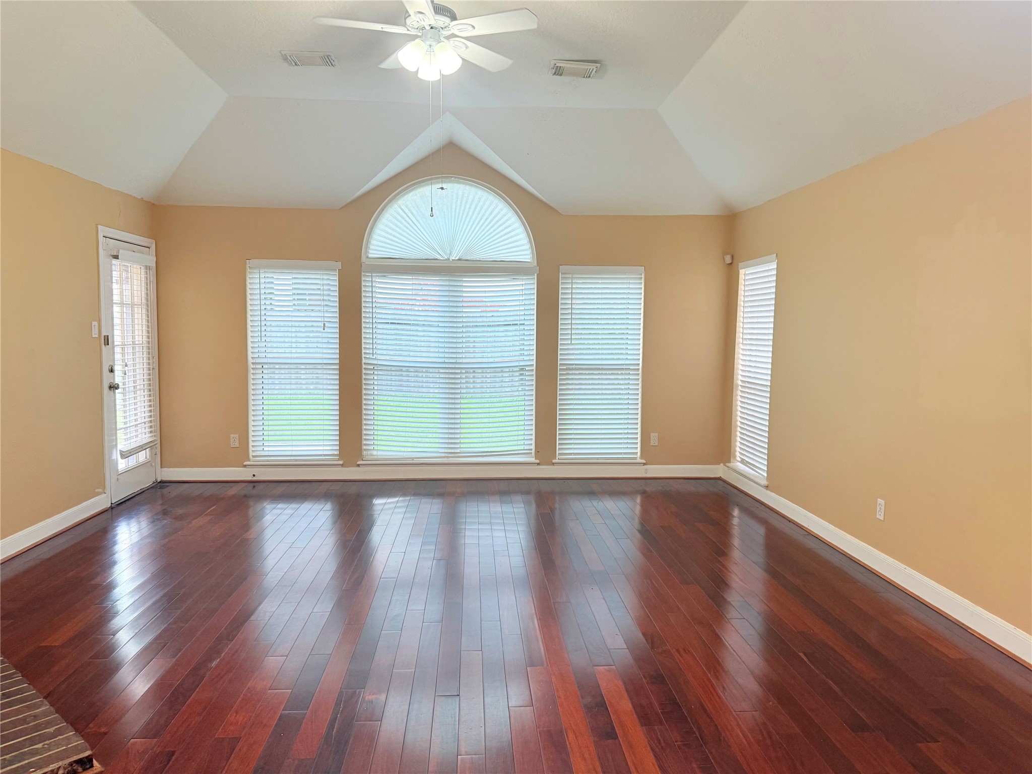 5010 Rebel Ridge Drive Sugar Land, TX 77478 - Photo 6 of 23 an empty room with wooden floor and windows