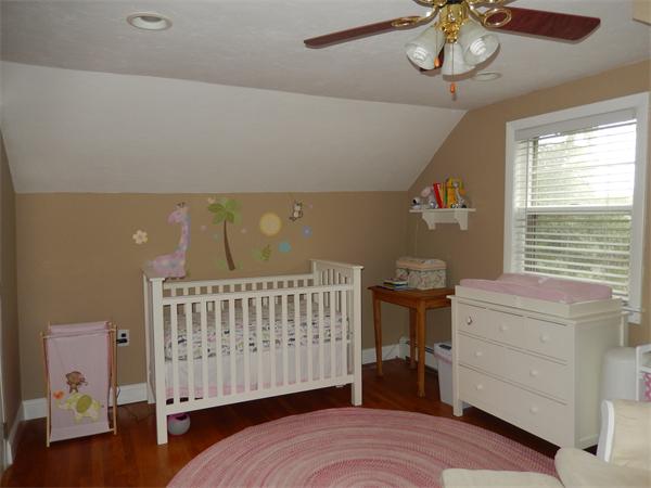 75 Chesbrough Road Boston, MA 02132 - Photo 12 of 16 a bedroom with a bed and a chandelier