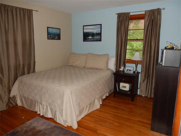 75 Chesbrough Road Boston, MA 02132 - Photo 5 of 16 a bed sitting in a bedroom next to a window