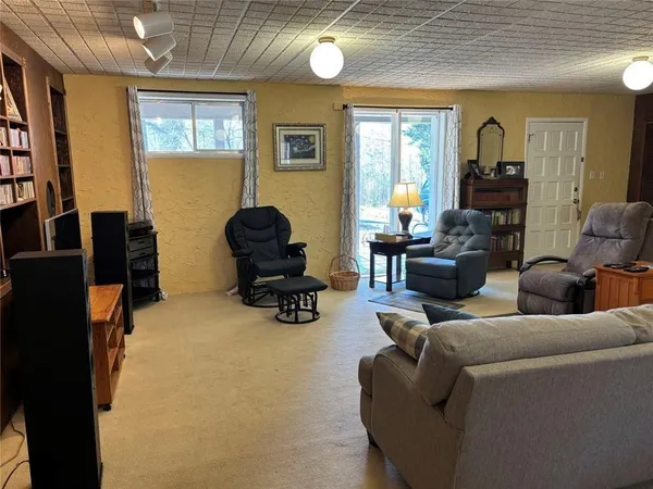 a spacious bedroom with a bed and wooden floor