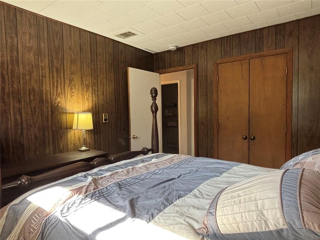 183 Barker Road Southwest Rome, GA 30165 - Photo 60 of 71 a bedroom with a bed and a mirror