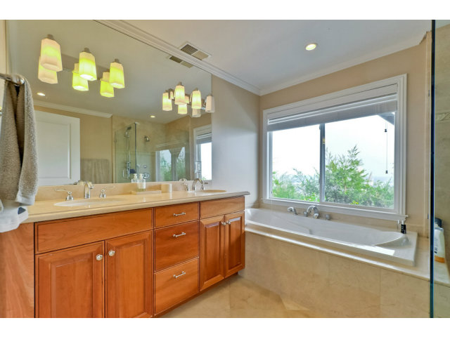 1606 Courtland Road Belmont, CA 94002 - Photo 11 of 17 a bathroom with a granite countertop sink a large mirror a vanity and a bathtub