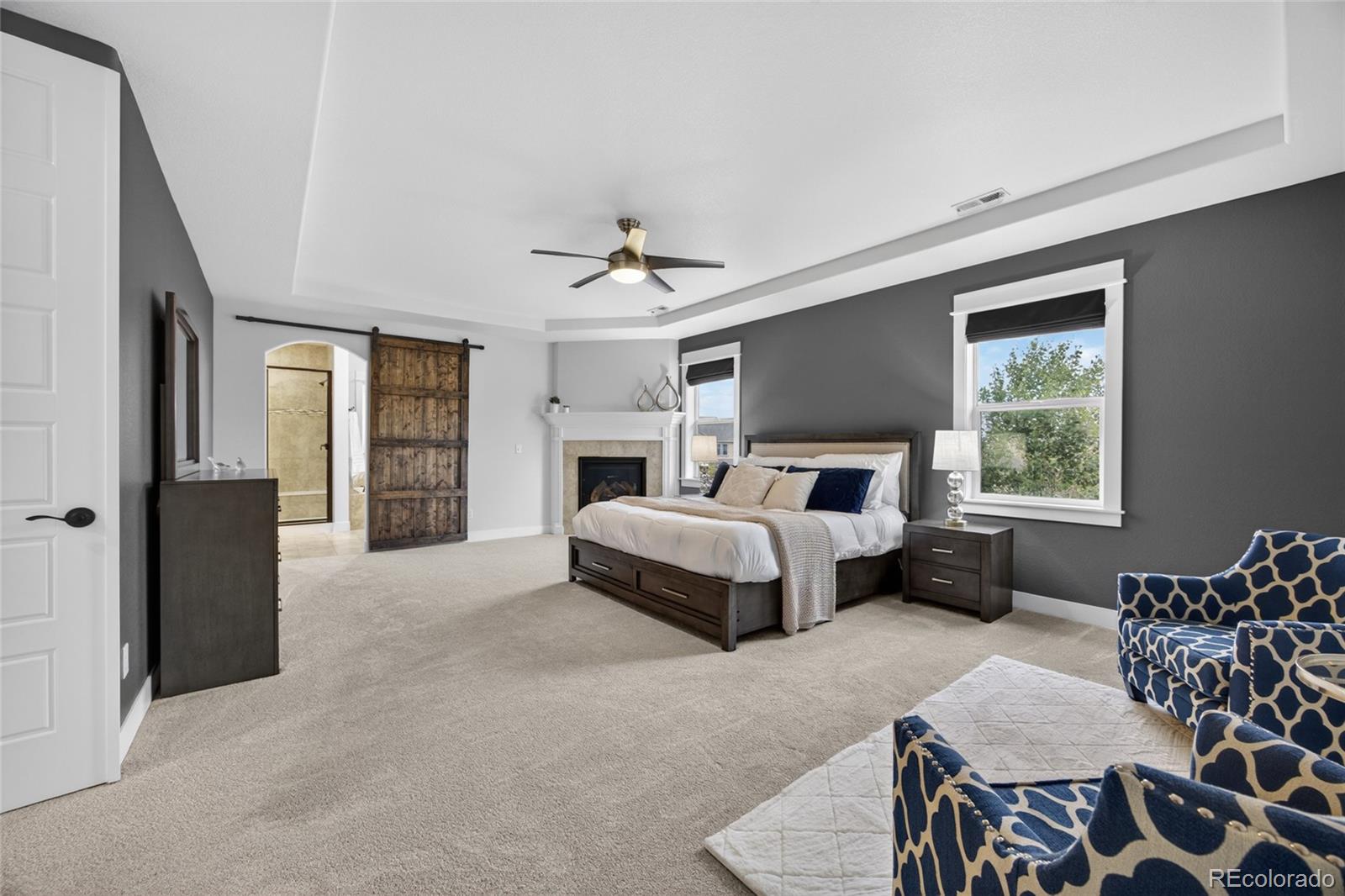 20554 East Shady Ridge Road Parker, CO 80134 - Photo 22 of 49 a bedroom with furniture and a fireplace