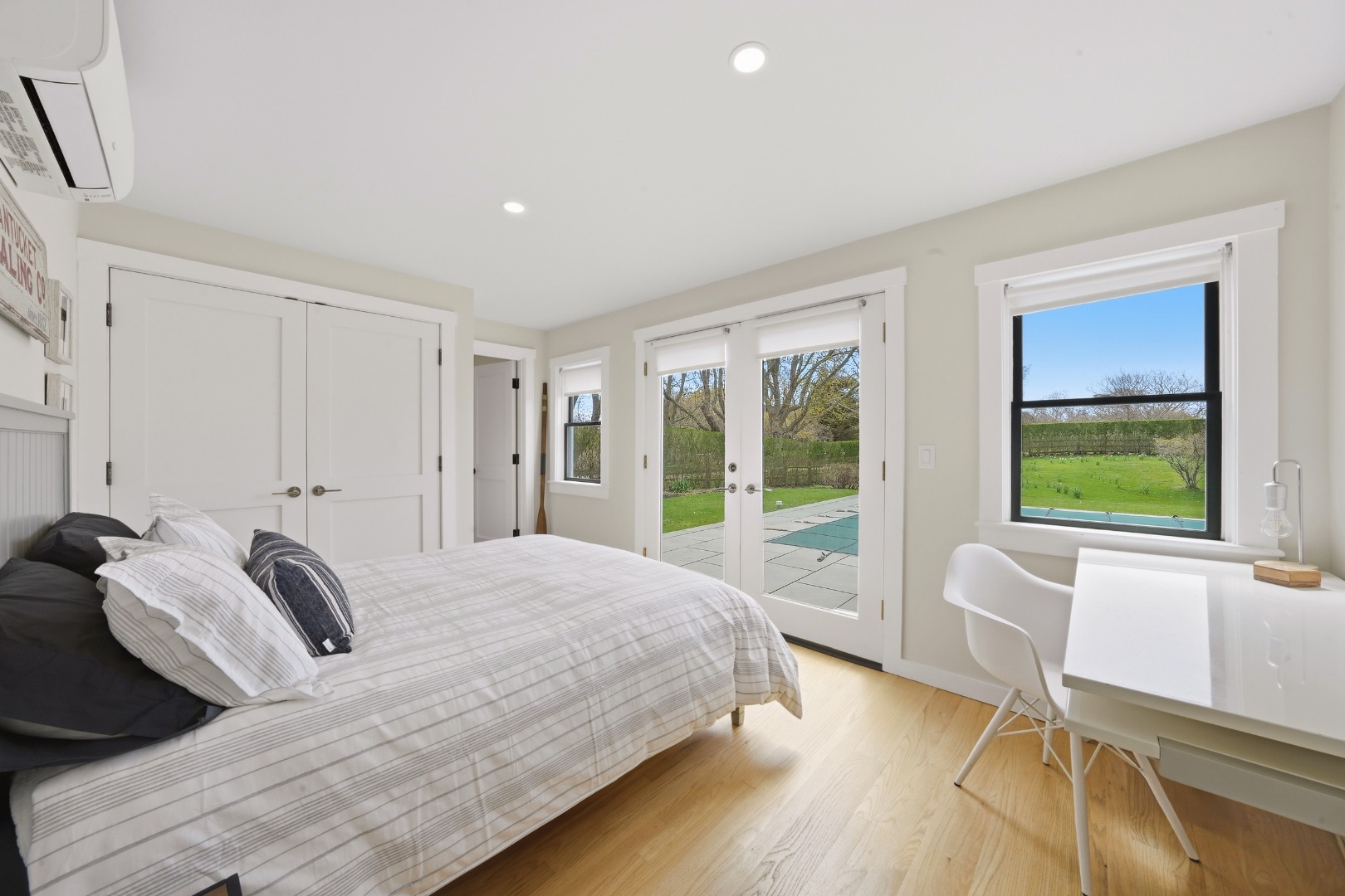 247 Polpis Road Nantucket, MA 02554 - Photo 30 of 52 a bedroom with a bed and large windows