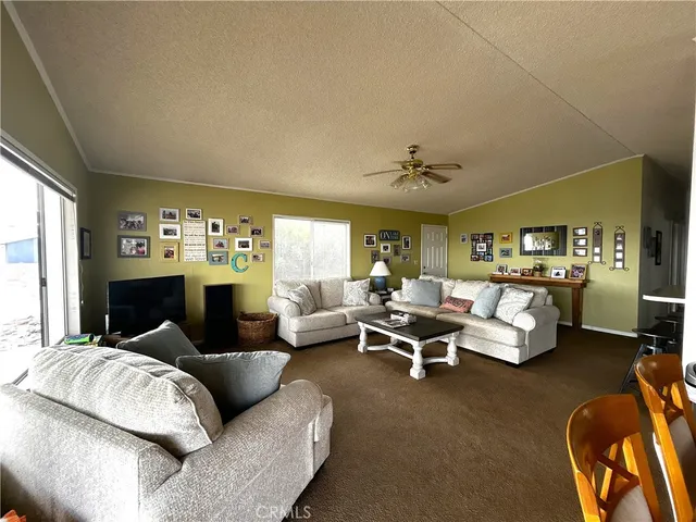 a living room with furniture wooden floor and a large window