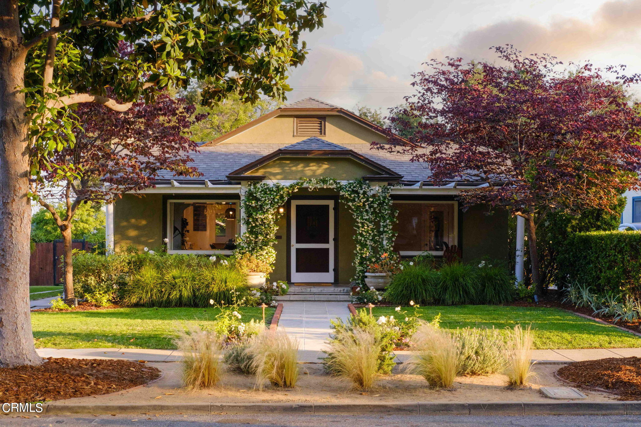 a front view of a house with garden