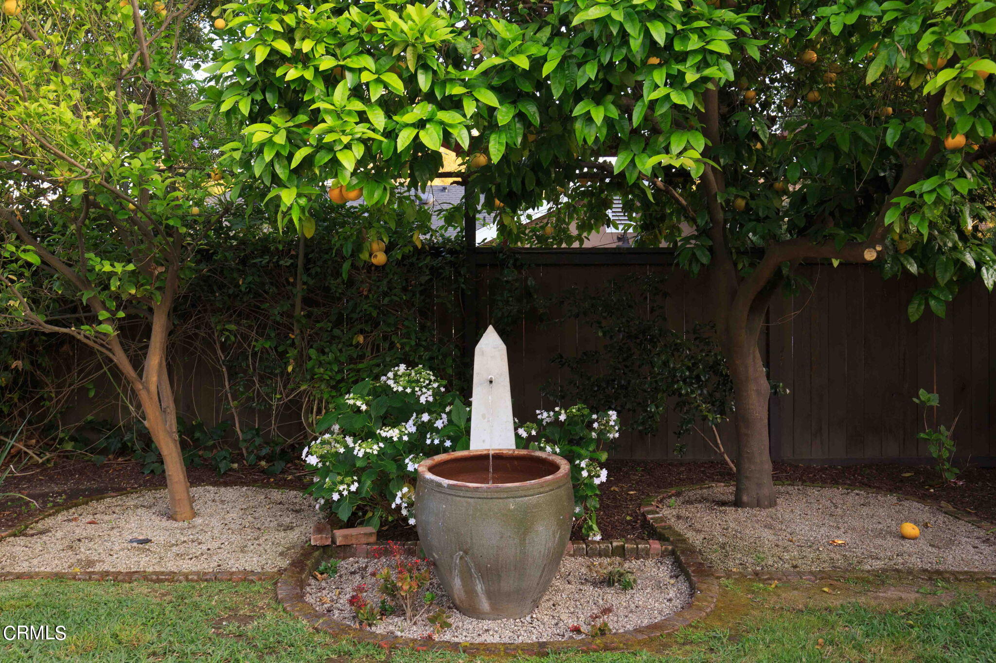 1864 Queensberry Road Pasadena, CA 91104 - Photo 35 of 40 a view of a backyard with fountain plants and large tree