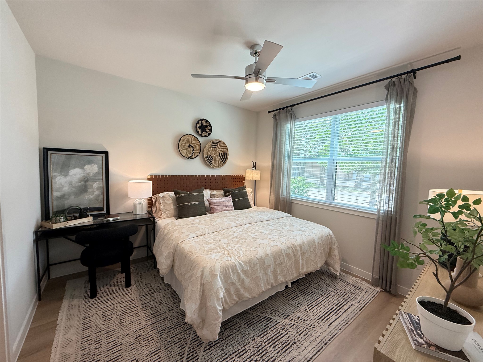 1610 Campbell Road, Unit B4 395 Houston, TX 77055 - Photo 7 of 12 a bedroom with a large bed and a chandelier
