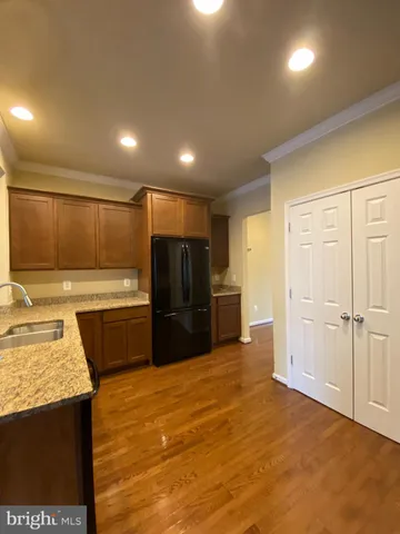 a kitchen with a refrigerator and a sink
